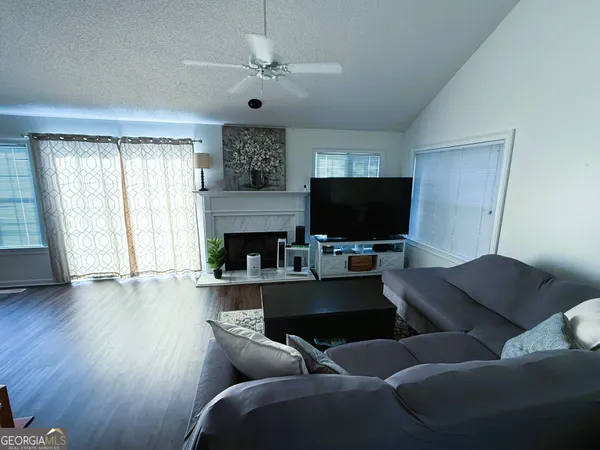 a living room with furniture and a flat screen tv