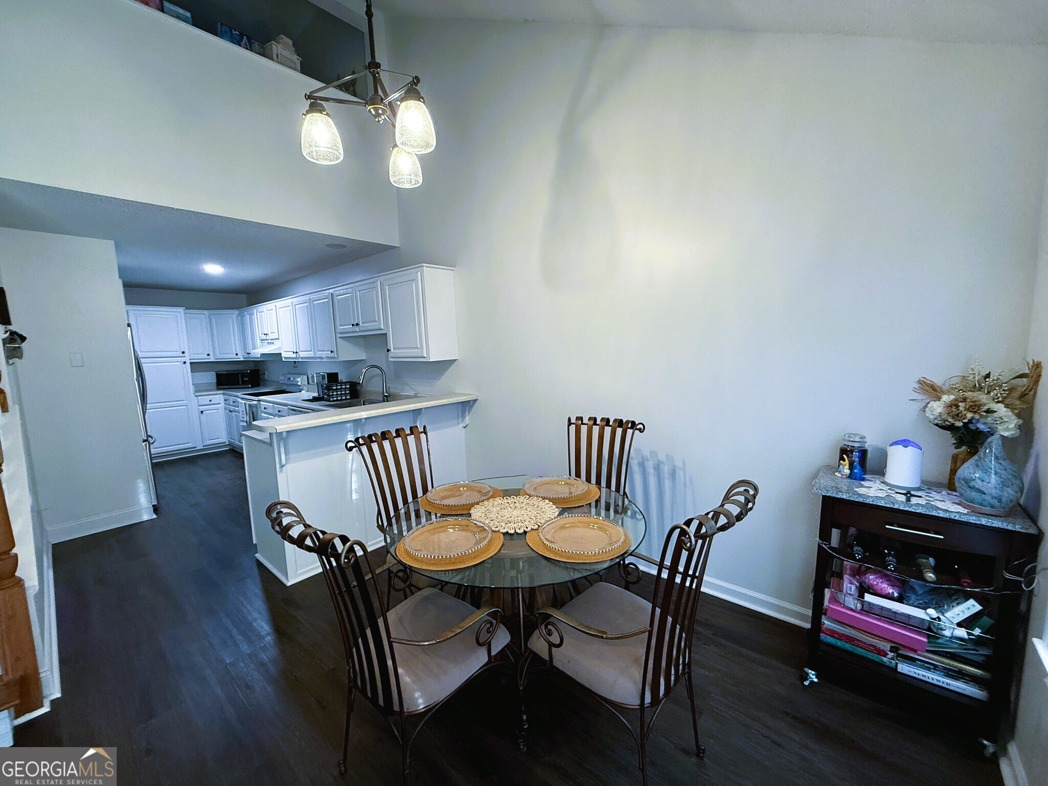 1910 North Loop Road, Unit 6B Vidalia, GA 30474 - Photo 20 of 39 a kitchen with granite countertop a dining table chairs and a refrigerator