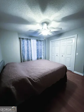 a spacious bedroom with a bed and a chandelier