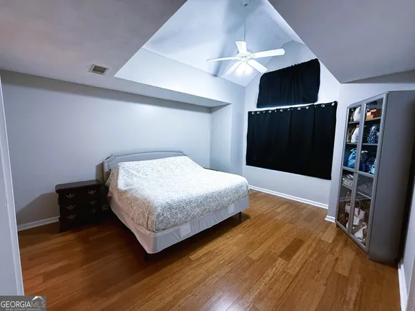 a bedroom with a bed and a television