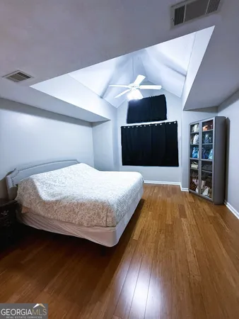 a bedroom with a bed and a television