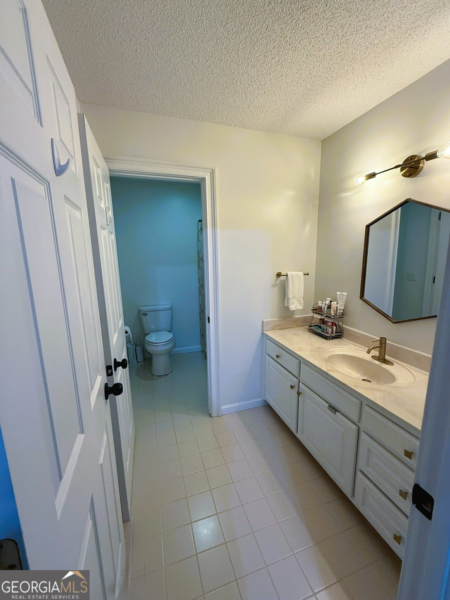 1910 North Loop Road, Unit 6B Vidalia, GA 30474 - Photo 36 of 39 a bathroom with a double vanity sink toilet and shower