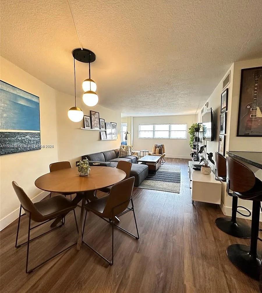 1881 Washington Avenue, Unit 4A Miami Beach, FL 33139 - Photo 5 of 15 a view of a dining room with furniture and wooden floor
