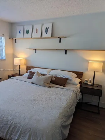 a bedroom with bed and window