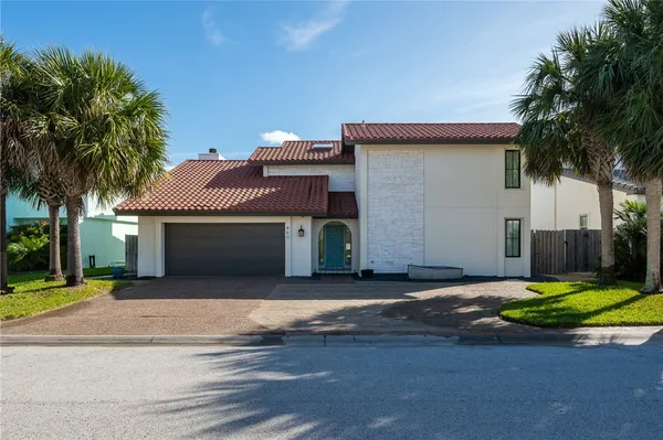 a view of a house with a yard and garage