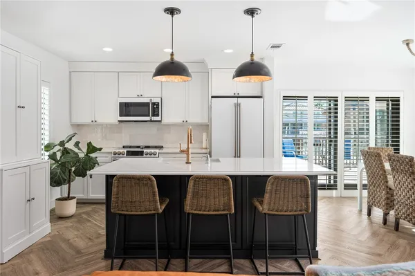 a dining table with chairs and window