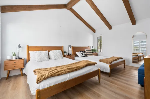 a spacious bedroom with a bed and a couch