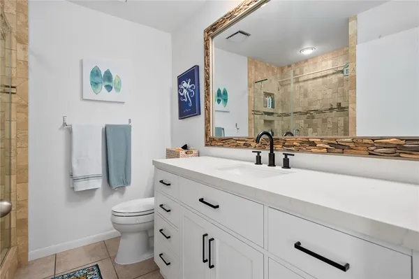 a bathroom with a sink mirror vanity and toilet