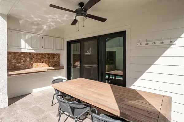 a dining room with wooden floor and entrance