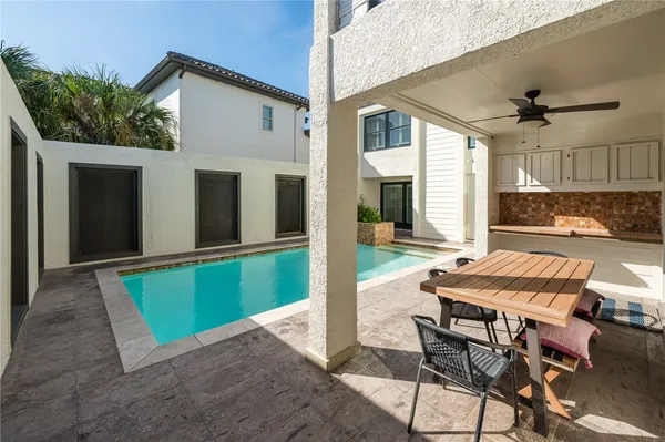 a view of a patio with table and chairs with wooden floor and plants