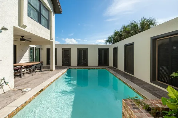 a swimming pool with outdoor seating and yard