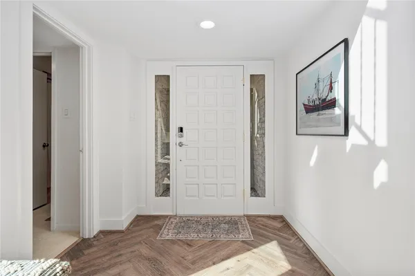 a bedroom with a bed and painting on the wall