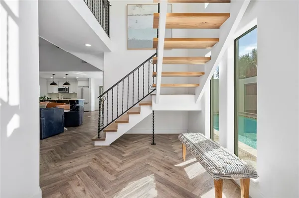 a view of entryway and hall with wooden floor