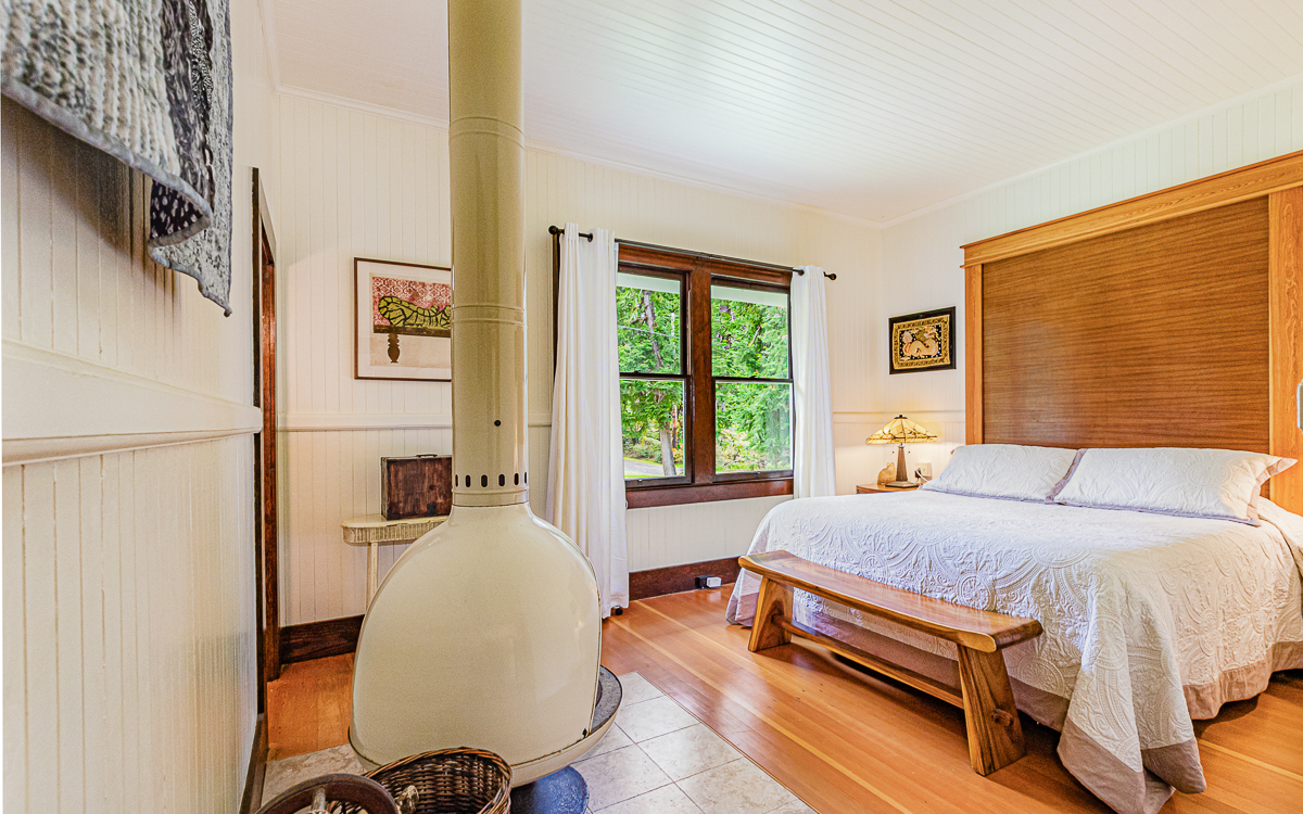 19-4029 Kilauea Road Volcano, HI 96785 - Photo 11 of 30 a bedroom with a bed and wooden floor