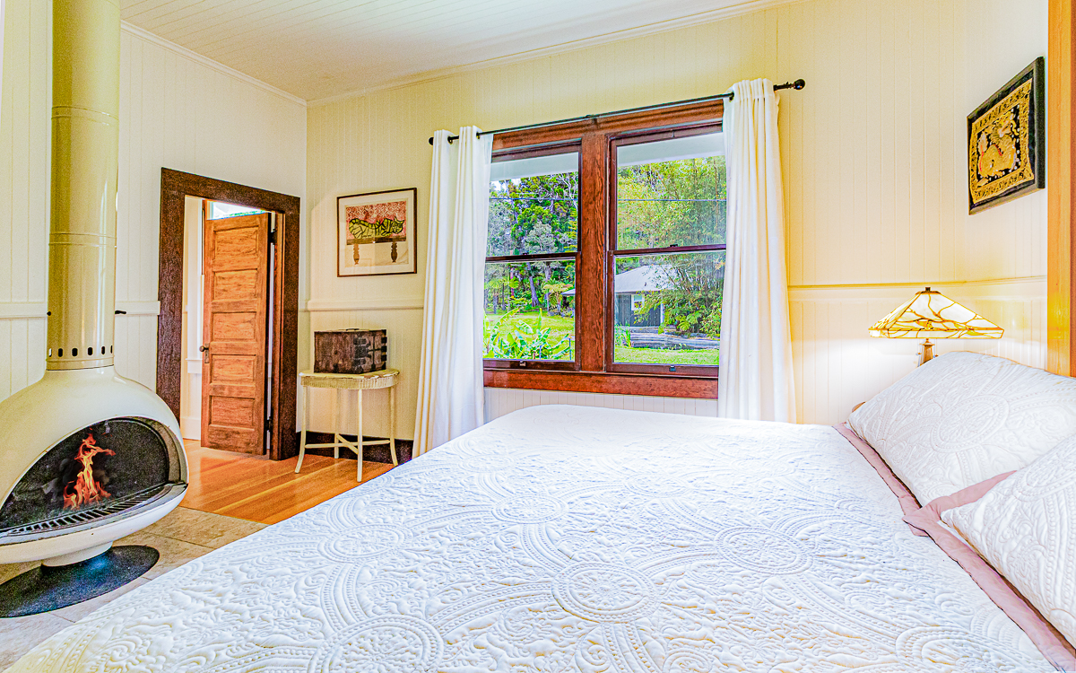 19-4029 Kilauea Road Volcano, HI 96785 - Photo 12 of 30 a bedroom with a bed and a large window