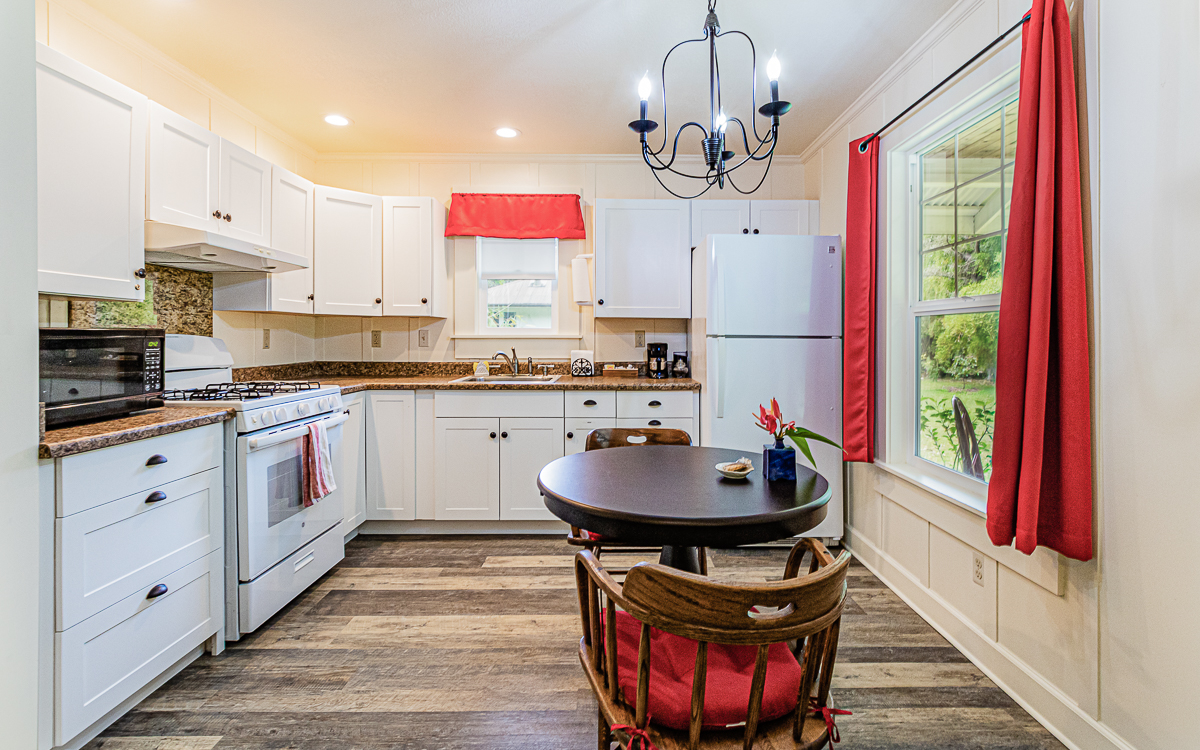 19-4029 Kilauea Road Volcano, HI 96785 - Photo 25 of 30 a kitchen with stainless steel appliances granite countertop a stove a sink and a refrigerator