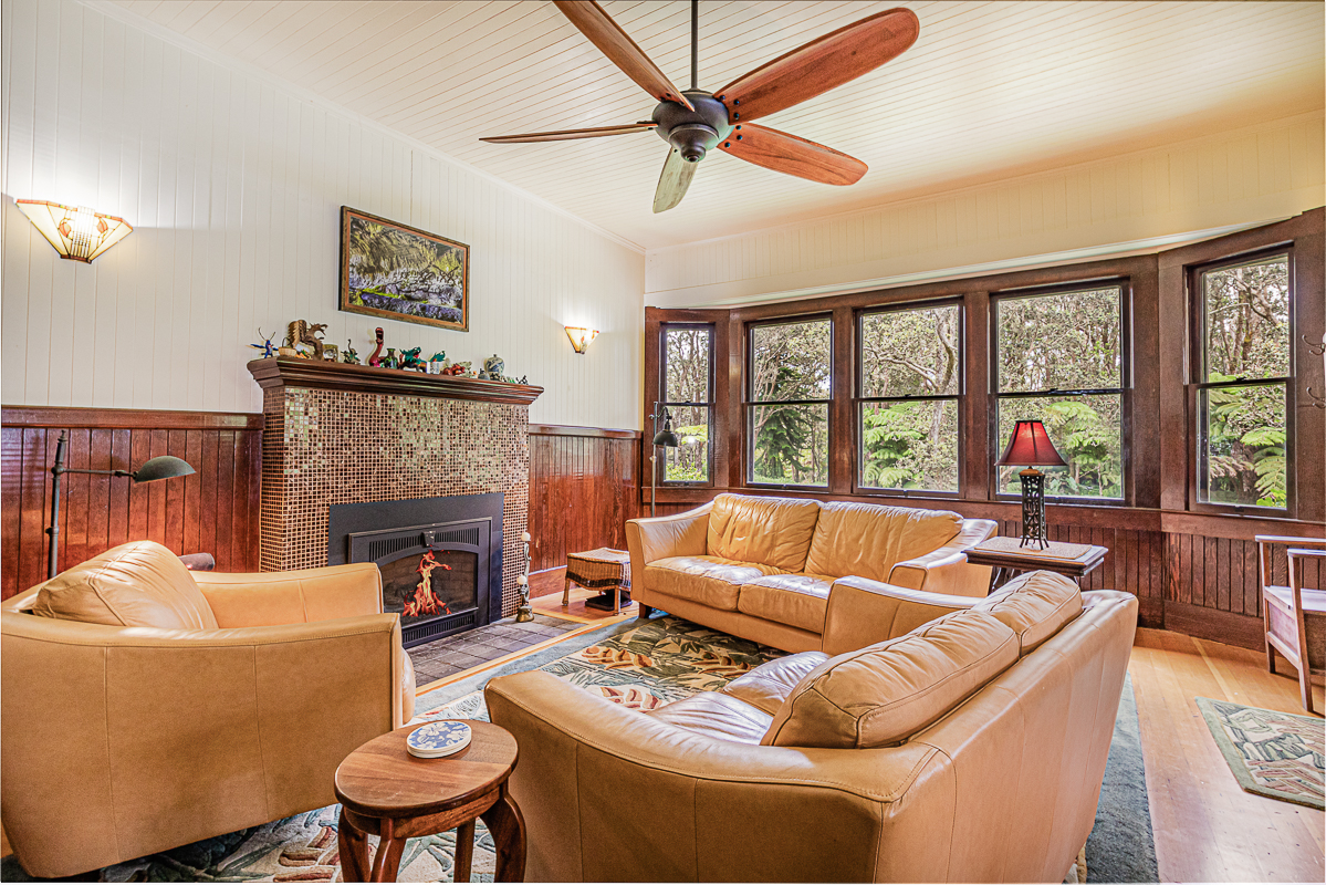 19-4029 Kilauea Road Volcano, HI 96785 - Photo 3 of 30 a living room with furniture a fireplace and a large window