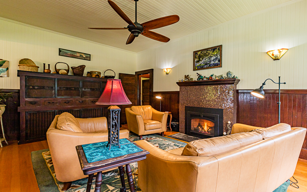 19-4029 Kilauea Road Volcano, HI 96785 - Photo 7 of 30 a living room with furniture a flat screen tv and a fireplace