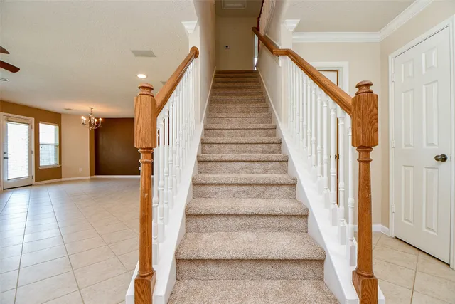a view of staircase with lots of frames and white walls