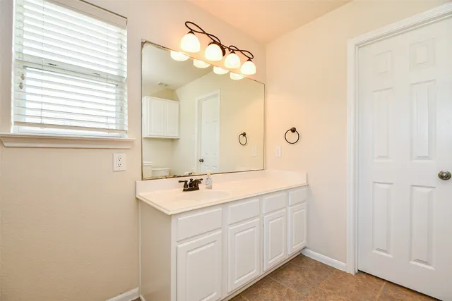 a bathroom with a sink a vanity and a mirror