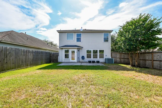 a view of a house with a yard and sitting area