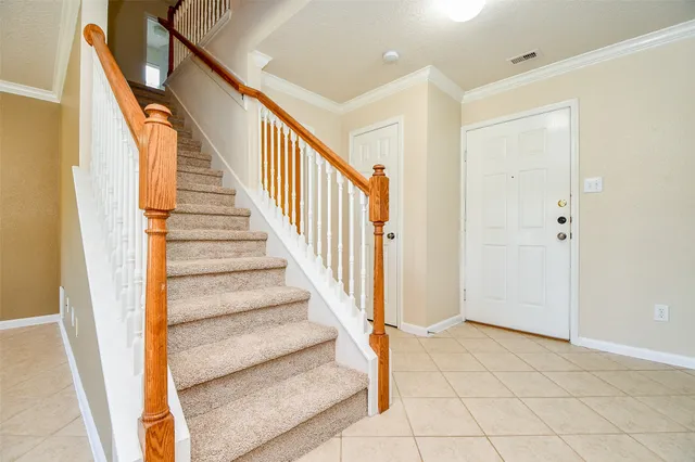 a view of staircase with wooden floor and door