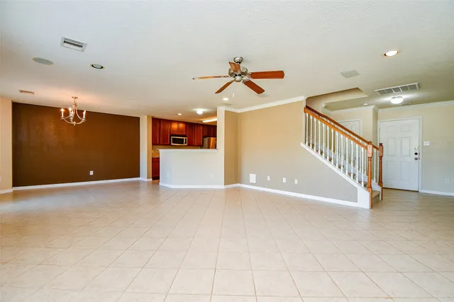 a view of a livingroom with a ceiling fan and window