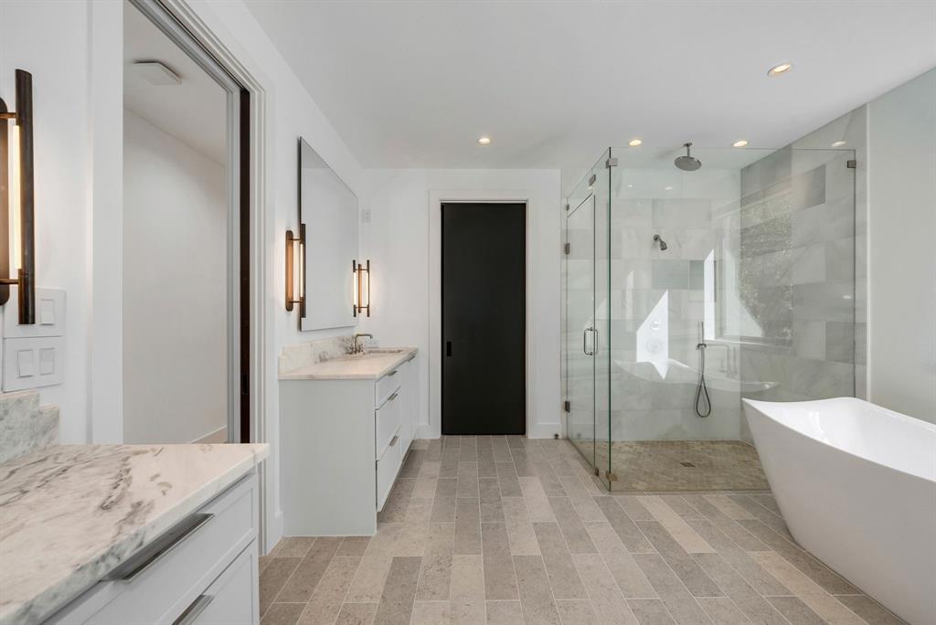 4214 Hawthorne Avenue Dallas, TX 75219 - Photo 19 of 39 a bathroom with a granite countertop tub sink toilet and shower