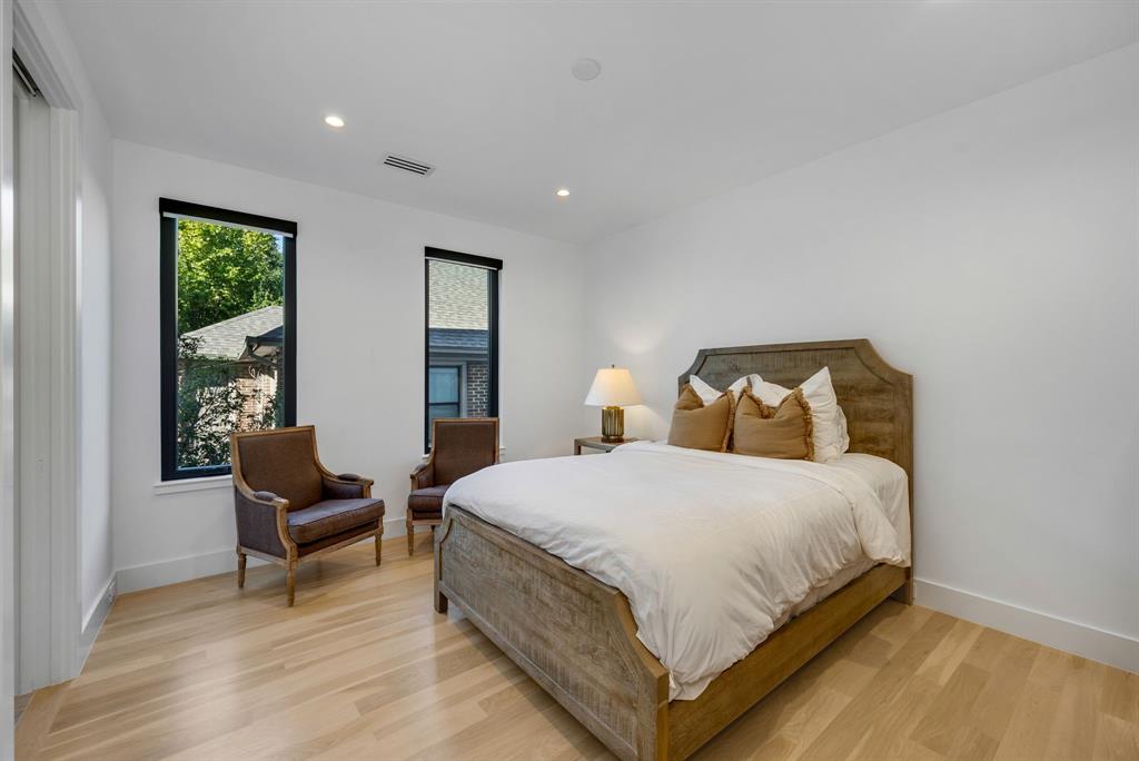 4214 Hawthorne Avenue Dallas, TX 75219 - Photo 20 of 39 a bedroom with a bed and chair