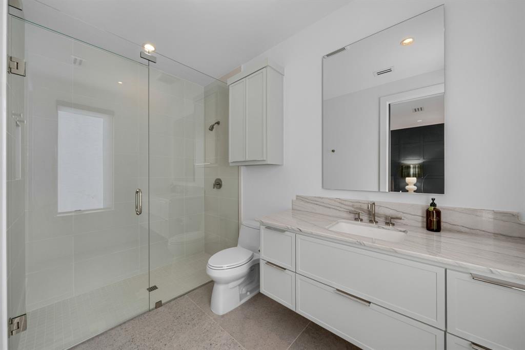 4214 Hawthorne Avenue Dallas, TX 75219 - Photo 21 of 39 a bathroom with a toilet sink and shower