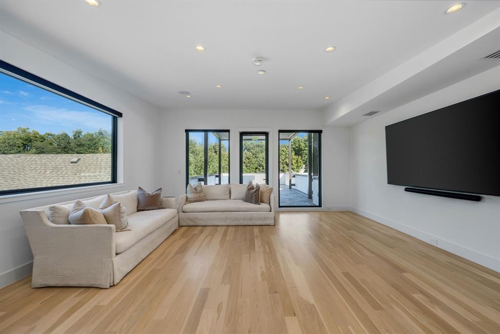 4214 Hawthorne Avenue Dallas, TX 75219 - Photo 24 of 39 a living room with furniture and a flat screen tv