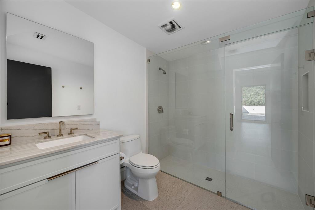 4214 Hawthorne Avenue Dallas, TX 75219 - Photo 26 of 39 a bathroom with a sink a toilet and shower