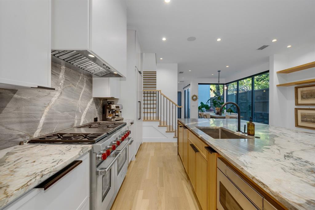 4214 Hawthorne Avenue Dallas, TX 75219 - Photo 5 of 39 a kitchen with kitchen island stainless steel appliances a sink stove and cabinets