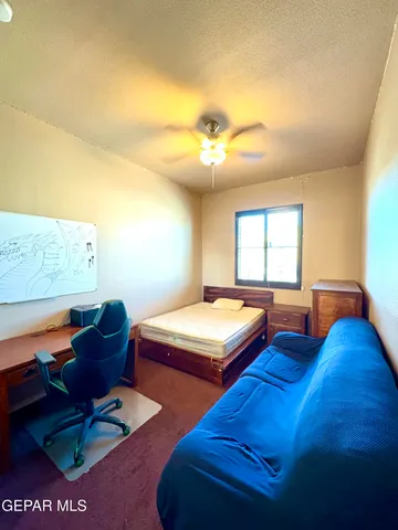 a bedroom with two beds and a couch