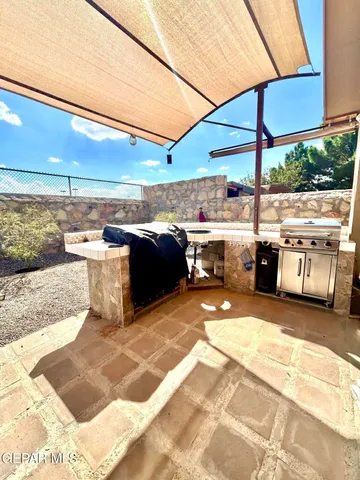 a view of roof deck with table and chairs under an umbrella