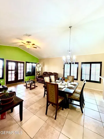 a view of a patio with dining table and chairs
