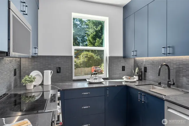 a kitchen with a sink a window and cabinets