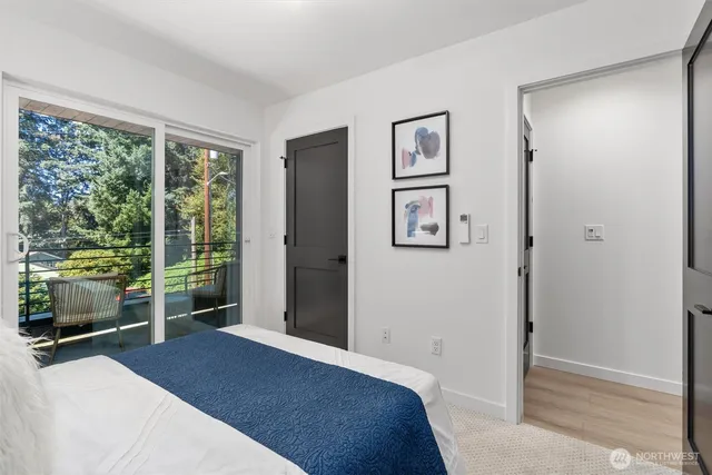 a bedroom with a bed and a large window