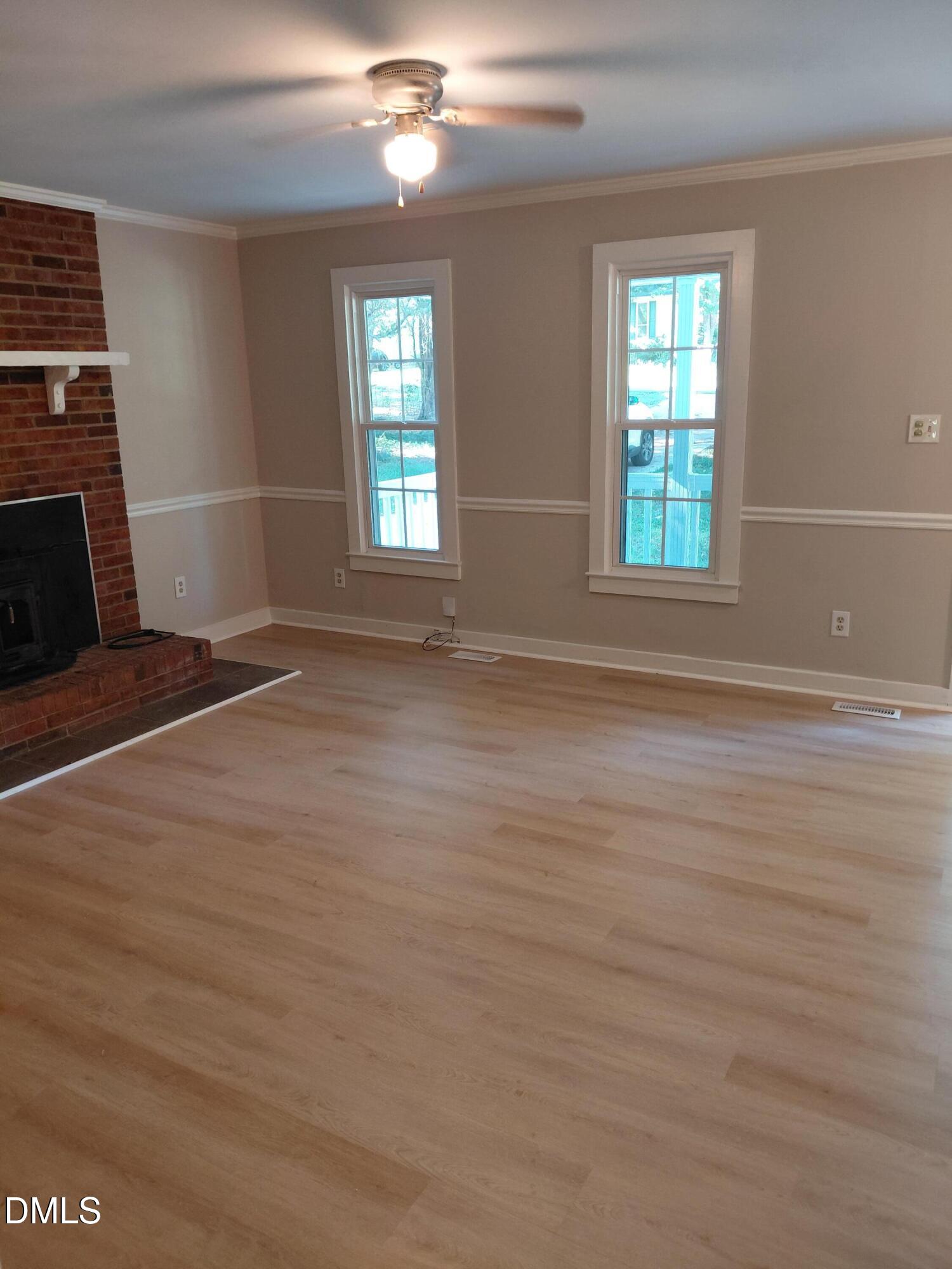 804 Olive Street Apex, NC 27502 - Photo 11 of 60 an empty room with windows and fireplace