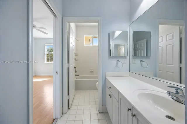 a spacious bathroom with a shower sink and mirror