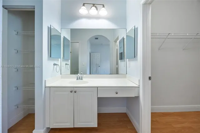 a bathroom with a double vanity sink and a mirror