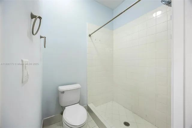 a white toilet sitting next to a bathroom