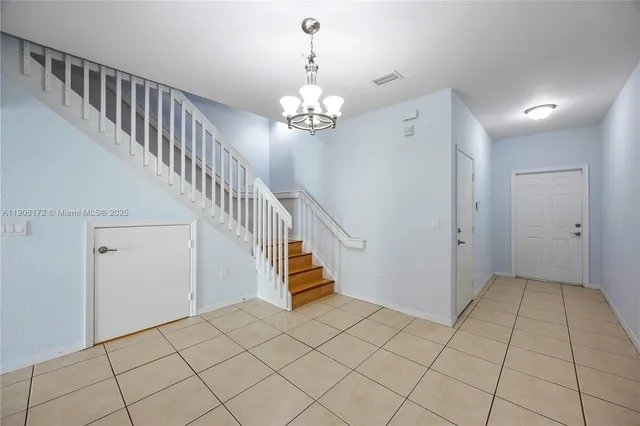 a view of an entryway with chandelier