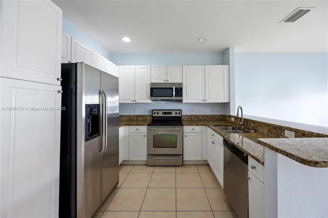 a kitchen with a sink stove and refrigerator
