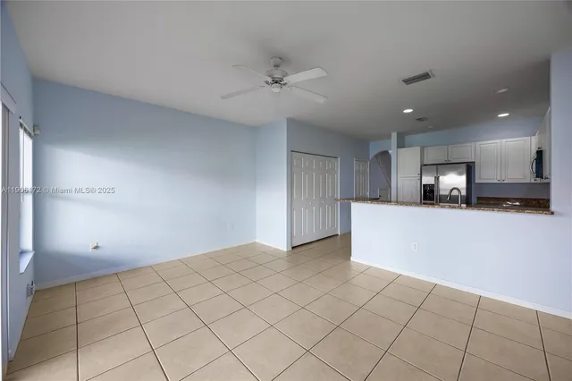 a view of a kitchen with a sink and a refrigerator
