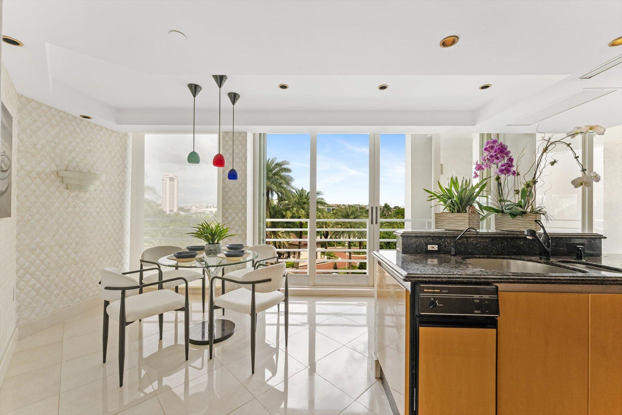 800 South Ocean Boulevard, Unit 303 Boca Raton, FL 33432 - Photo 12 of 49 a kitchen with stainless steel appliances granite countertop sink stove and white cabinets