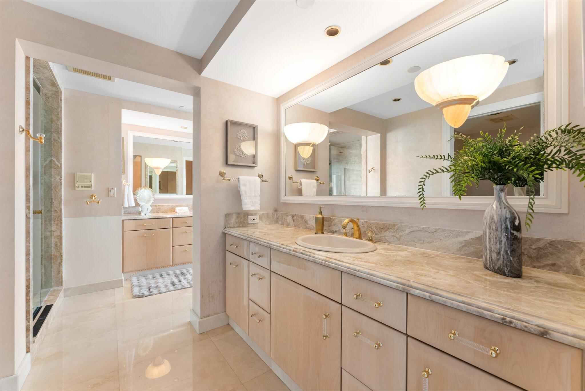 800 South Ocean Boulevard, Unit 303 Boca Raton, FL 33432 - Photo 25 of 49 a spacious bathroom with a sink a mirror and a shower
