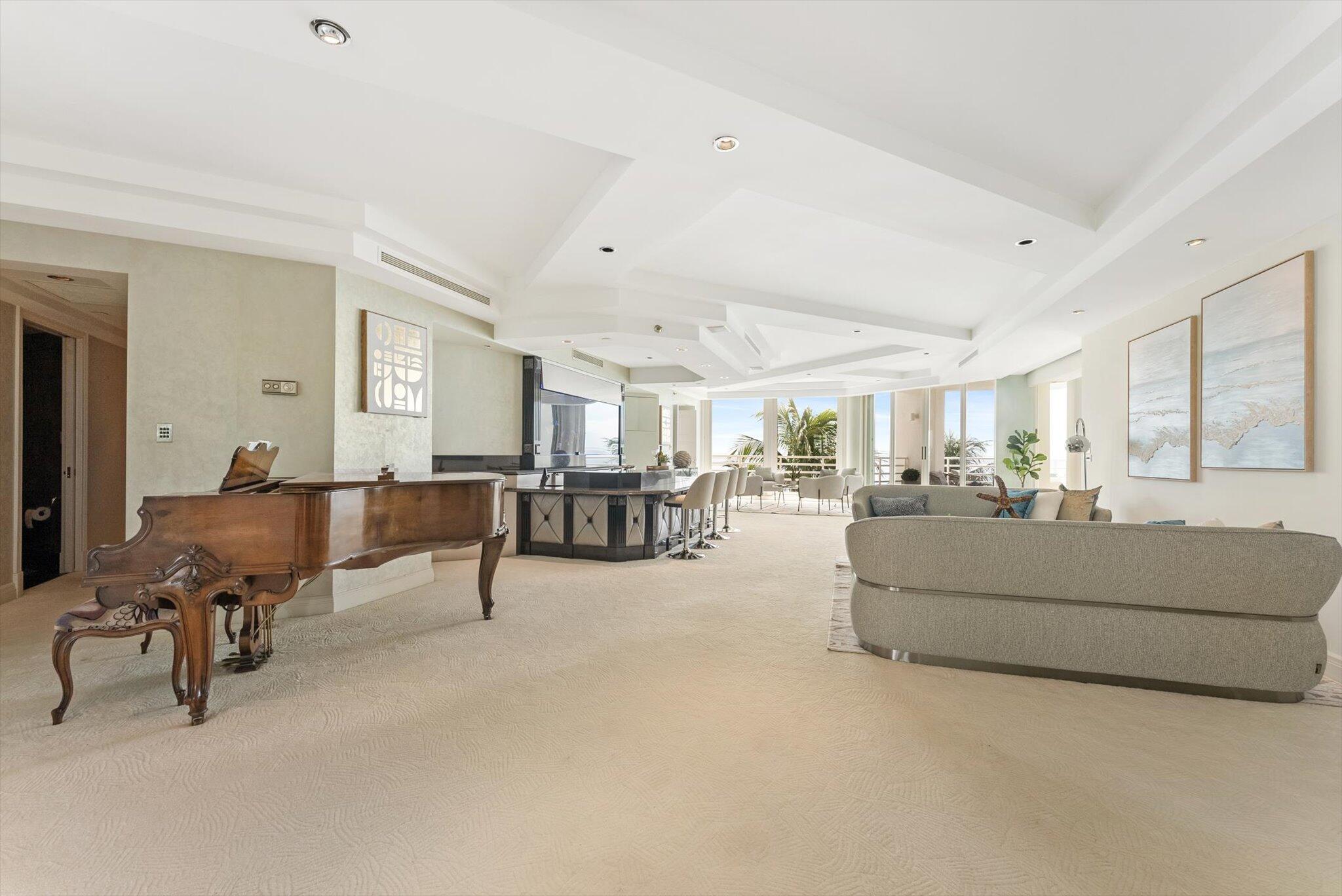 800 South Ocean Boulevard, Unit 303 Boca Raton, FL 33432 - Photo 6 of 49 a living room with furniture and a table