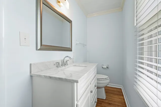 a bathroom with a sink toilet and mirror