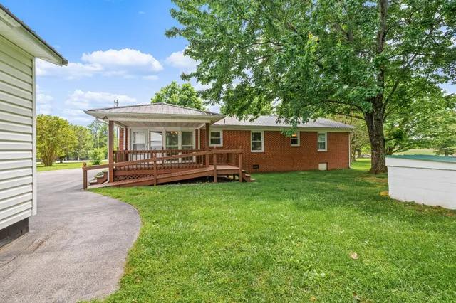 a view of a house with a backyard and a patio